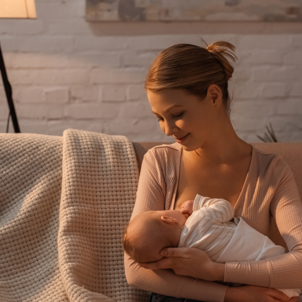 Mum holding her baby close, breastfeeding and gazing at baby
